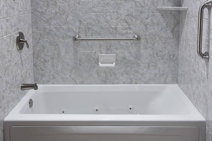 Bathtub installed and plumbed during a bathroom renovation