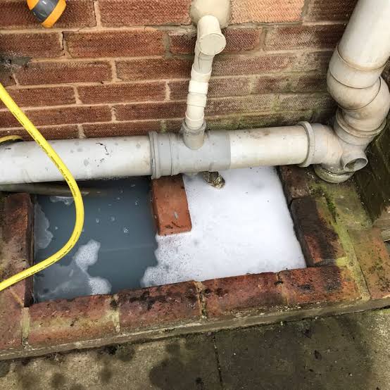 Plumber clearing a blocked toilet drain in Pretoria