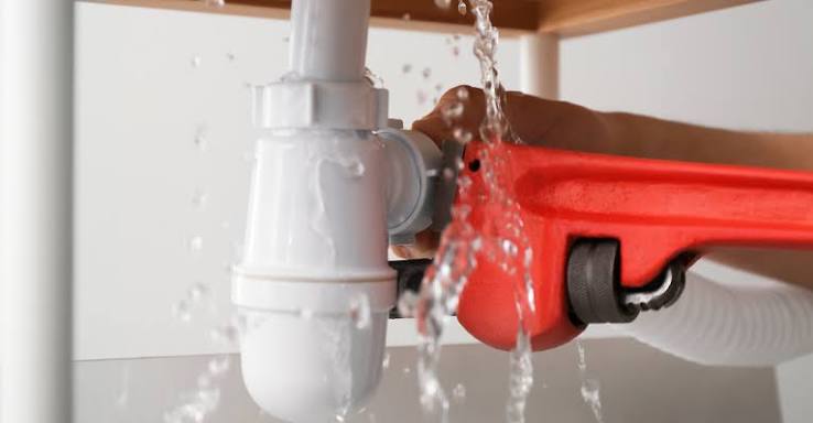 Plumber running a CCTV camera inspection through a drain