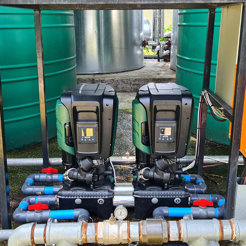 Plumbed pipework connecting a water pump to a storage tank
